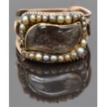 Georgian mourning ring set with plaited hair in a teardrop shaped glass setting surrounded by seed