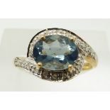 A 9ct gold ring set with an oval blue fire opal and diamonds, 2.2g, size N