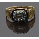 Victorian mourning ring set with hair in a central glass compartment, seed pearls and black