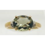 A 9ct gold ring set with a green fire opal and diamonds, 1.9g, size N