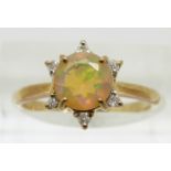 A 9ct gold ring set with a round cut opal surrounded by diamonds, 1.7g, size N