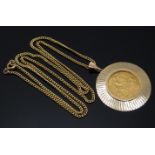 A 1911 gold half sovereign in 9ct gold pendant on 9ct gold chain, 12.1g