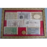 A collection of early 20thC German banknotes etc in frames, 34 x 49cm