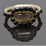 Georgian mourning ring set with plaited hair in a glass compartment surrounded by French jet,