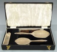 Hallmarked silver mounted dressing table set comprising hand mirror, two brushes and comb, in fitted