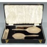 Hallmarked silver mounted dressing table set comprising hand mirror, two brushes and comb, in fitted