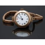 A 9ct gold ladies wristwatch with blued hands, Roman numerals, white enamel dial and unsigned