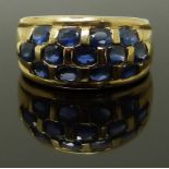 A 9ct gold ring set with oval cut sapphires, size M/N, 4.90g