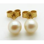 A pair of 9ct gold earrings set with a pearl to each