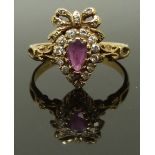 A 9ct gold ring set with a pear cut ruby and diamonds, size L/M, 2.35g