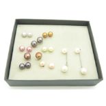Nine pairs of silver earrings set with various coloured pearls