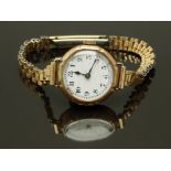 Swiss 9ct gold ladies wristwatch with blued hands, black Arabic numerals, white enamel dial and