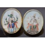 Two 19thC Indian yellow metal buttons set with ivory painted panels depicting wolf gods, 3 x 2.5cm