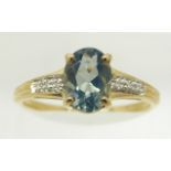 A 9ct gold ring set with an oval blue fire opal and diamonds, 1.6g, size N