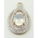 A 9ct gold ring set with an oval cut ice opal surrounded by topaz, 3.3g