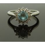 An 18ct white gold ring set with a round cut zircon surrounded by diamonds, 3.9g, size J/K