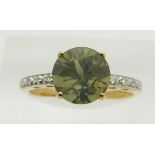 A 9ct gold ring set with a round cut green fire opal and diamonds, 2.2g, size N