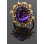 Edwardian 9ct gold ring set with a cushion cut amethyst surrounded by seed pearls, size P/Q, 8.23g