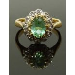 An 18ct gold ring set with a tourmaline and diamonds, size G, 3.24g