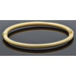 A 9ct gold bangle with a textured finish, 5.4g