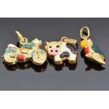 Three 9ct gold and enamel charms, one in the form of a cow, one a parrot and the other a