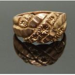 A 9ct rose gold keeper ring with floral decoration, size J, 4.17g