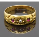 An 18ct gold ring set with a diamond and rubies in a G.W.Harvey Wellington box, size O, 2.87g