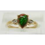 A 9ct gold ring set with a pear cut Mezezo opal and diamonds, 1.6g, size M