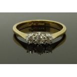 An 18ct gold ring set with three diamonds, size J/K, 2.22g