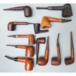 A collection of wooden smoking pipes including Grosvenor, St Claude, Loewe and Colby, Ford T,