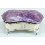 George V hallmarked silver jewellery box with shaped lid, padded lid and raised on four feet,