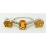 A 9ct white gold ring set with an oval cut fire opal and diamonds and a pair of 9ct gold earrings