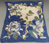 Christian Dior silk scarf decorated with flowers on a blue and ivory ground, 75 x 75cm