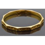 A 9ct gold bangle with engraved scrolling decoration, 6.1g