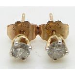 Pair of 9ct gold earrings each set with a diamond measuring approximately 0.12ct