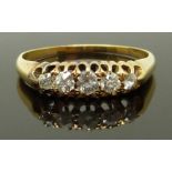 An 18ct gold ring set with five diamonds, size L, 2.69g