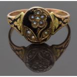 Victorian mourning ring set with seed pearls in the form of a flower on black enamel ground and with