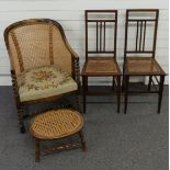 Three bergere chairs, one with tapestry upholstery, barley twist legs and a footstool