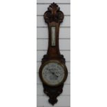 Early 20thC carved oak advertising aneroid barometer, the painted dial 'with compliments from