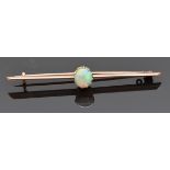 A late Victorian/ early Edwardian 9ct rose gold brooch set with an opal cabochon, 3.2g