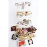 A collection of costume jewellery including Sarah Coventry brooches, necklaces, earrings including