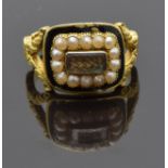 An 18ct gold mourning ring set with plaited hair, seed pearls and black enamel, with engraved