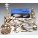 A collection of plated ware including a wine coaster, fish servers, grape scissors, cutlery,