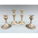 Two pairs of hallmarked silver candlesticks, one pair Birmingham 1957 the other 1945, height of