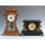 A 19thC American gingerbread clock with Roman dial and alarm feature, 56cm tall together with a faux