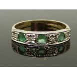 A 9ct gold ring set with emeralds and diamonds in a platinum setting, size I/J, 1.57g