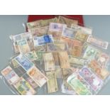 An amateur collection of world banknotes, in an album