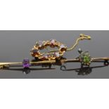 A bar brooch set with an amethyst, a gilt brooch set with garnets and another brooch