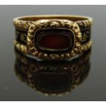 Georgian 18ct gold mourning ring set with a glass compartment surrounded by black enamel and foliate