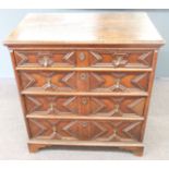 An antique oak chest of two over three graduated drawers with shaped drawer fronts, drop handles and